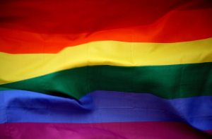 An LGBTQ pride flag, with rainbow stripes