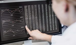 A data scientist analyzes metrics on a data chart.