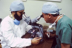 Two medical scientists use a double-headed microscope to conduct research.