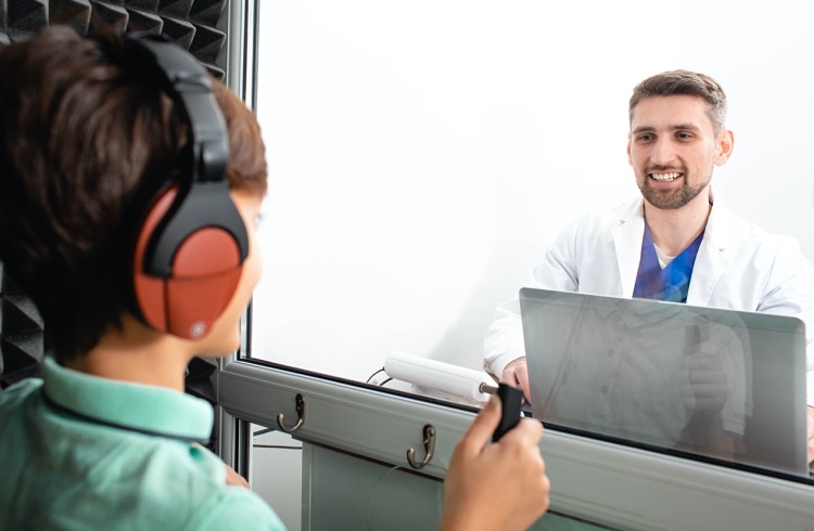 An audiologist administers a hearing test.