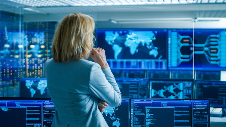 CIA agent analyzes information in a system control room.