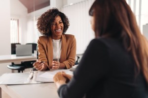 A smiling accountant meets with a client