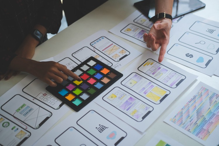 UX designers laying out prototype designs for a mobile app.