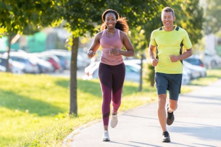 Two joggers in a park.