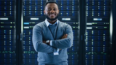 Smiling man standing in front of server
