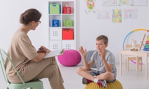 Woman social worker chatting with kid