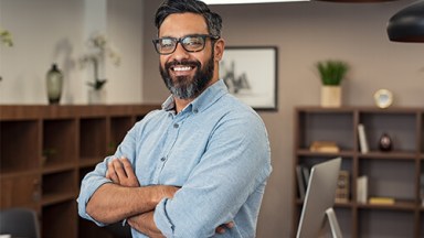 Smiling man standing in modern office