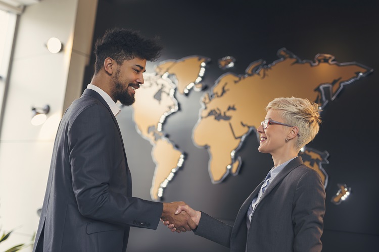 International marketing executives shaking hands.