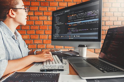 Woman coding on computer