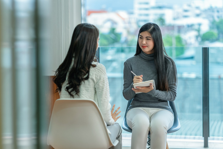 Youth counselor has discussion with teen client. 