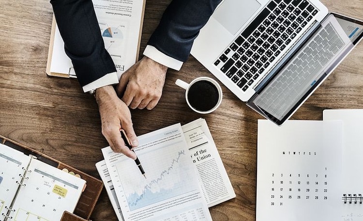 hand pointing to chart during business meeting