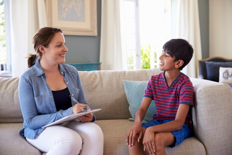 A child welfare social worker meets with her young client.