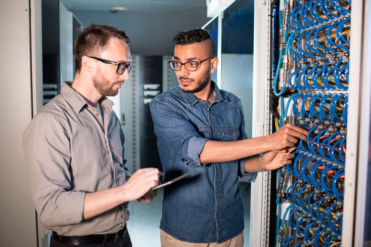 Two computer support specialists in a data center