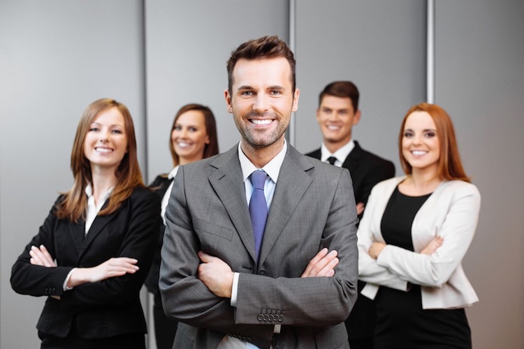 group of smiling finance professionals with arms crossed