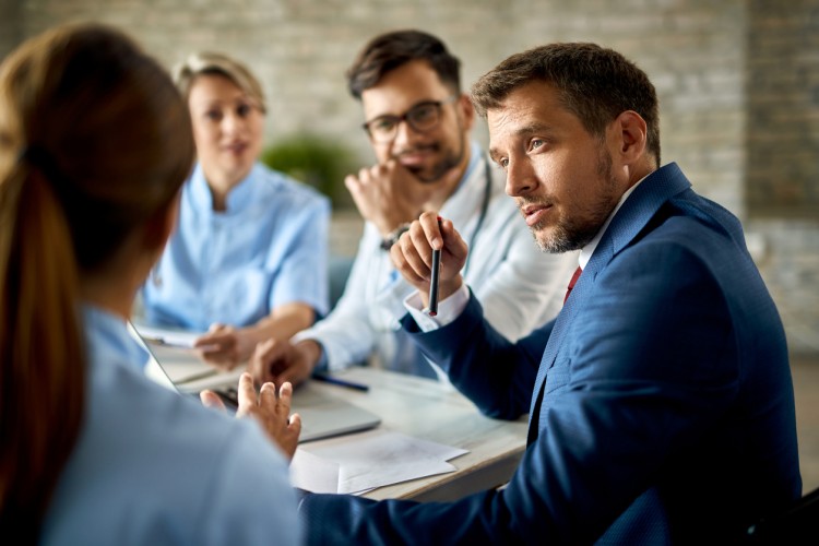 An office manager meets with medical staff