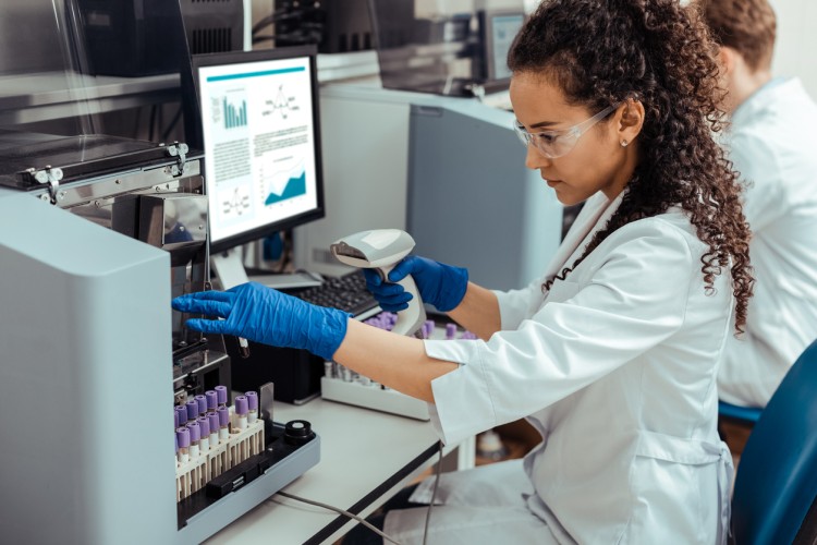 A medical technologist analyzes a sample