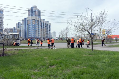 Probationers clean up litter in the city for community service.