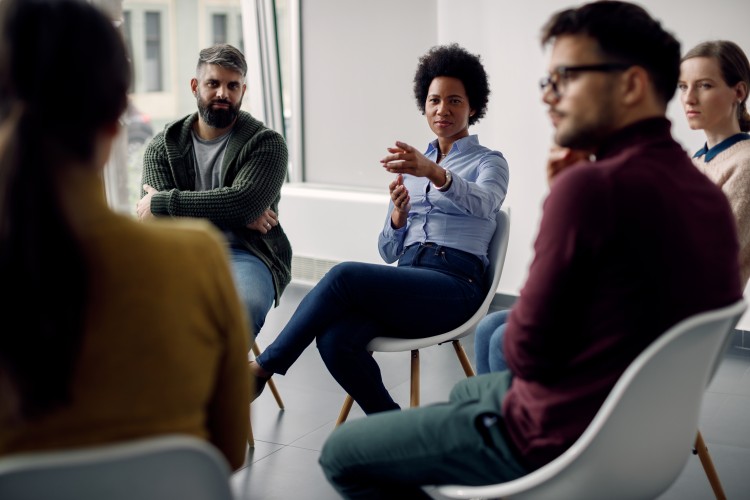 Group of people sitting in a circle during a social work training. 