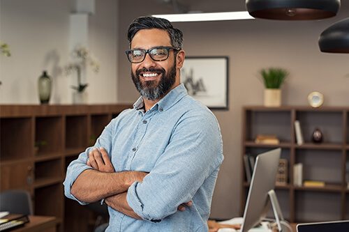 Smiling man standing in modern office