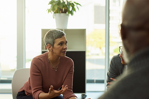 woman talking to other people