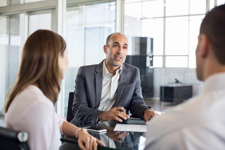 Manager conducting a meeting with his team. 