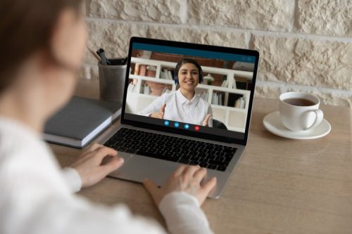 An employee and manager conduct a performance review via video conference.